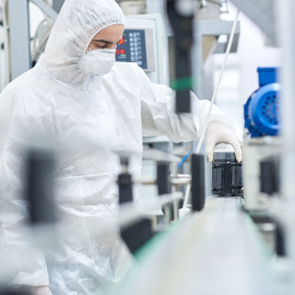 lab worker pouring chemicals